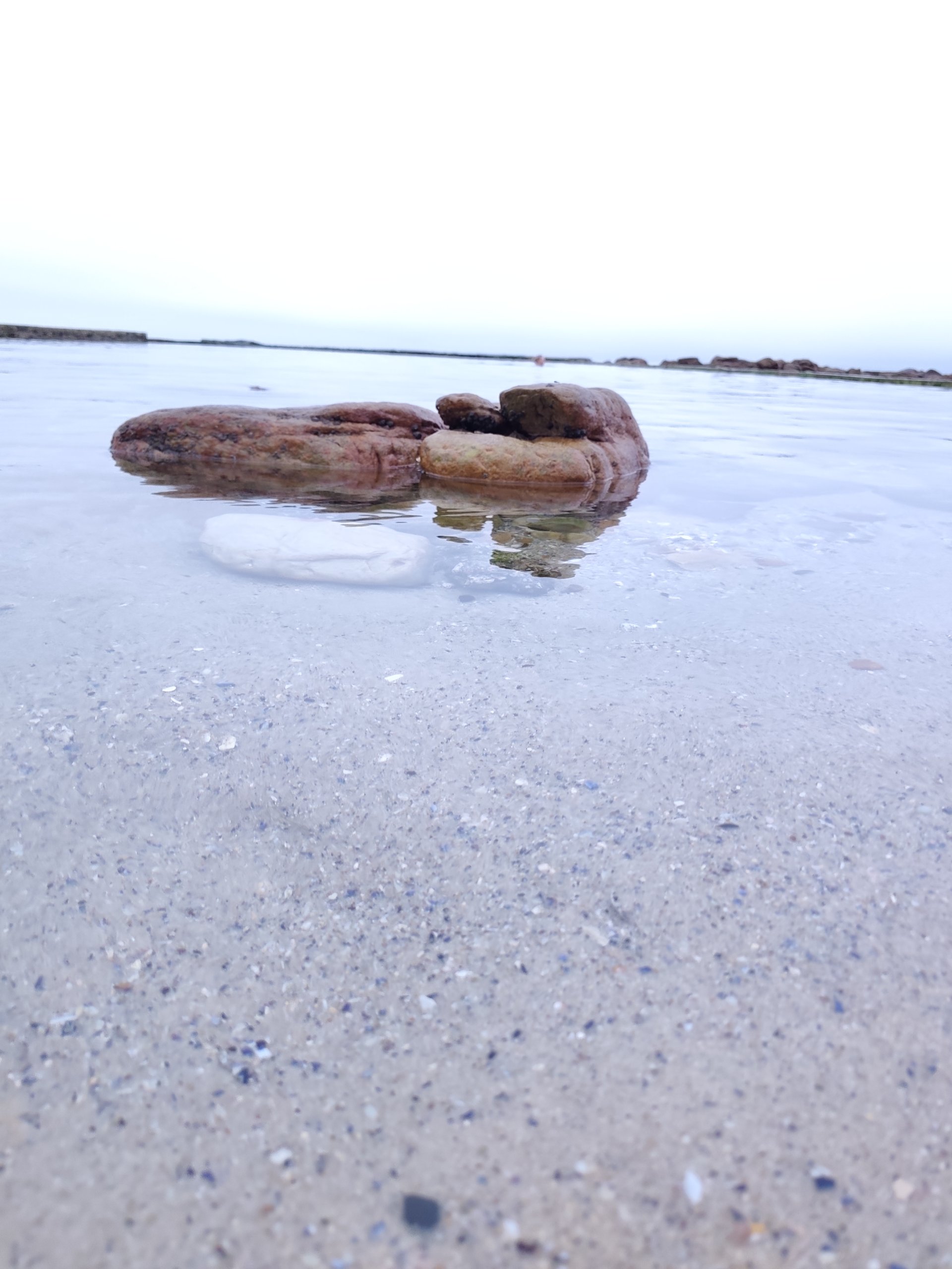a rock in the tranquil waters of St James Tidal Pool near Kalk Bay, Cape Town. The perfect spot for a morning swim along the Cape Peninsula drive
